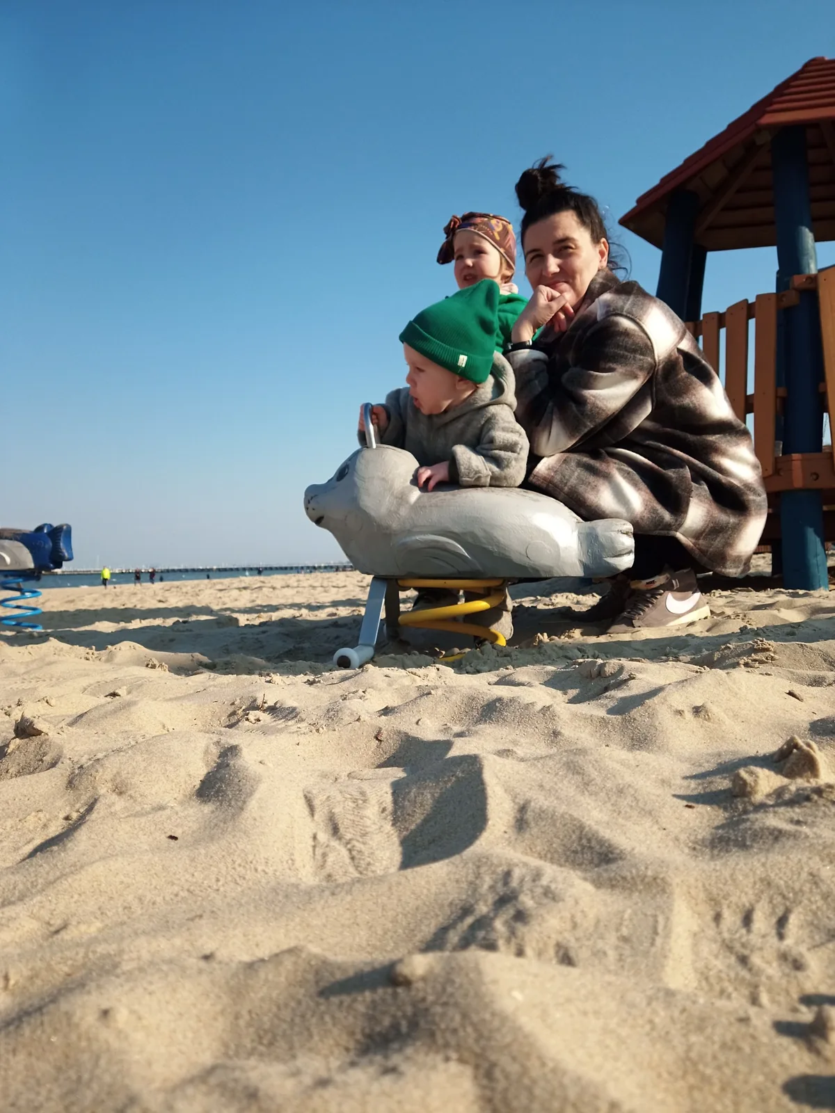 Family at the beach playground beside Centrala Rybna in Sopot