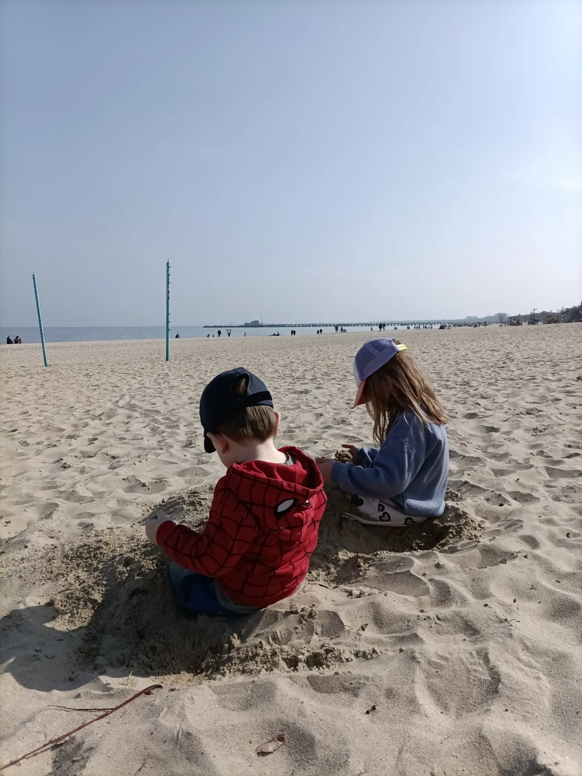 Children playing in the sand on a Baltic beach in Gdańsk