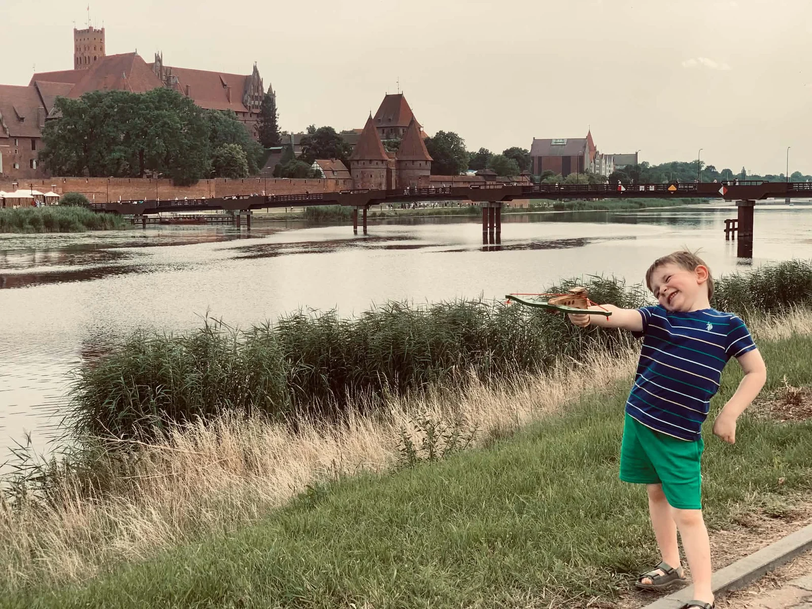 Our child by Malbork Castle during a family visit