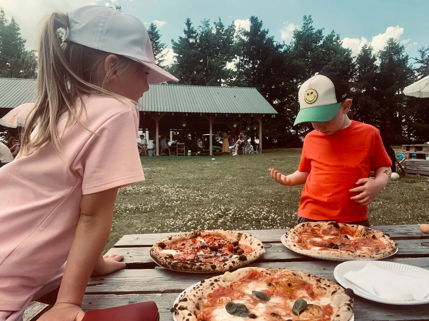 Our children eating pizza at Pizza w Sadzie near Gdańsk