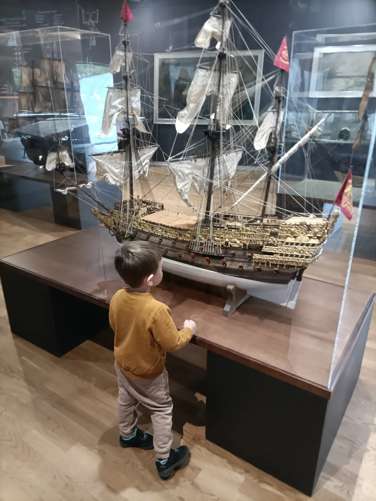 Child looking at a historic ship model in the Polish Naval Museum in Gdynia
